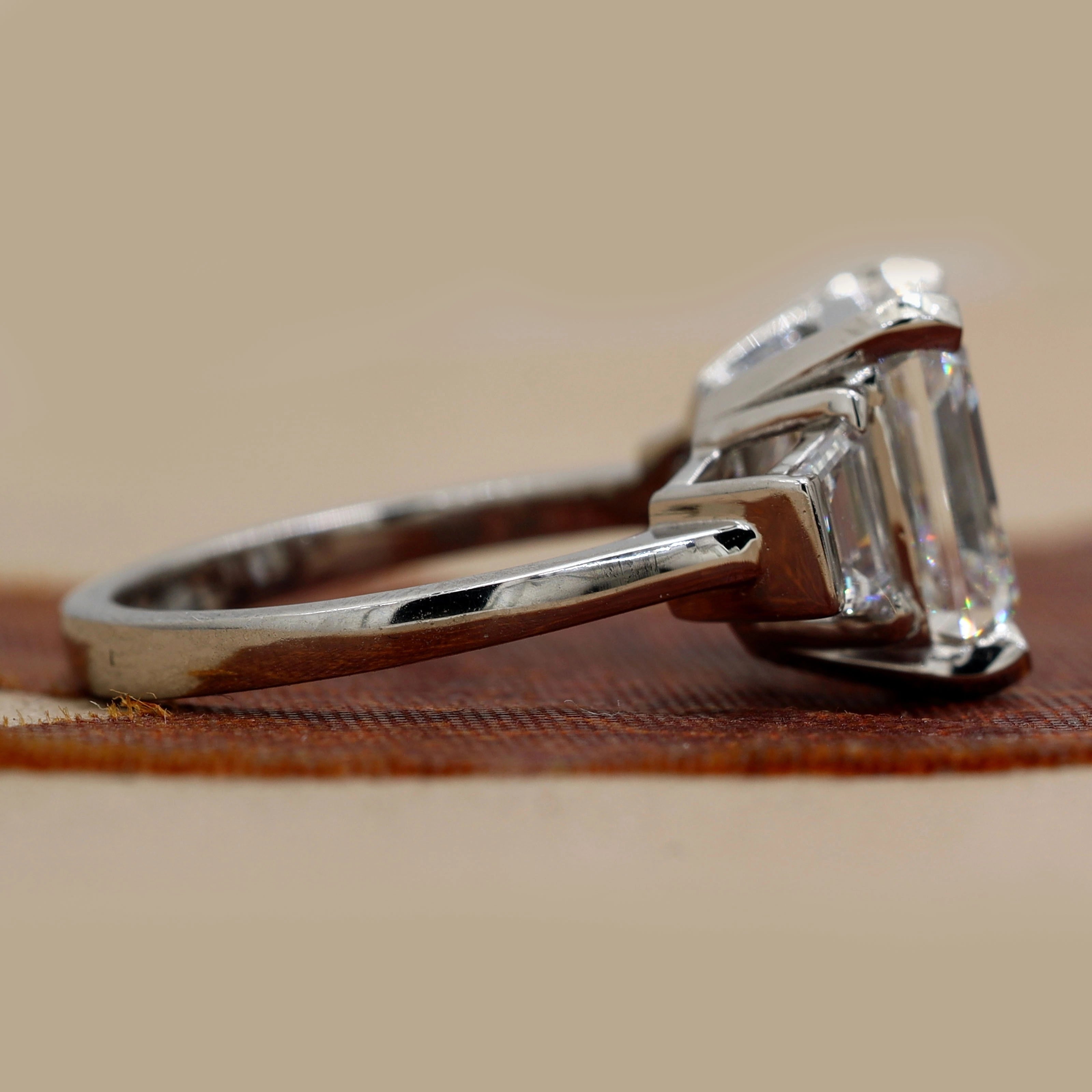 Side View Of 6.84 Ct Asscher Cut Three Stone Diamond Engagement Ring with Step-Cut Side Stones