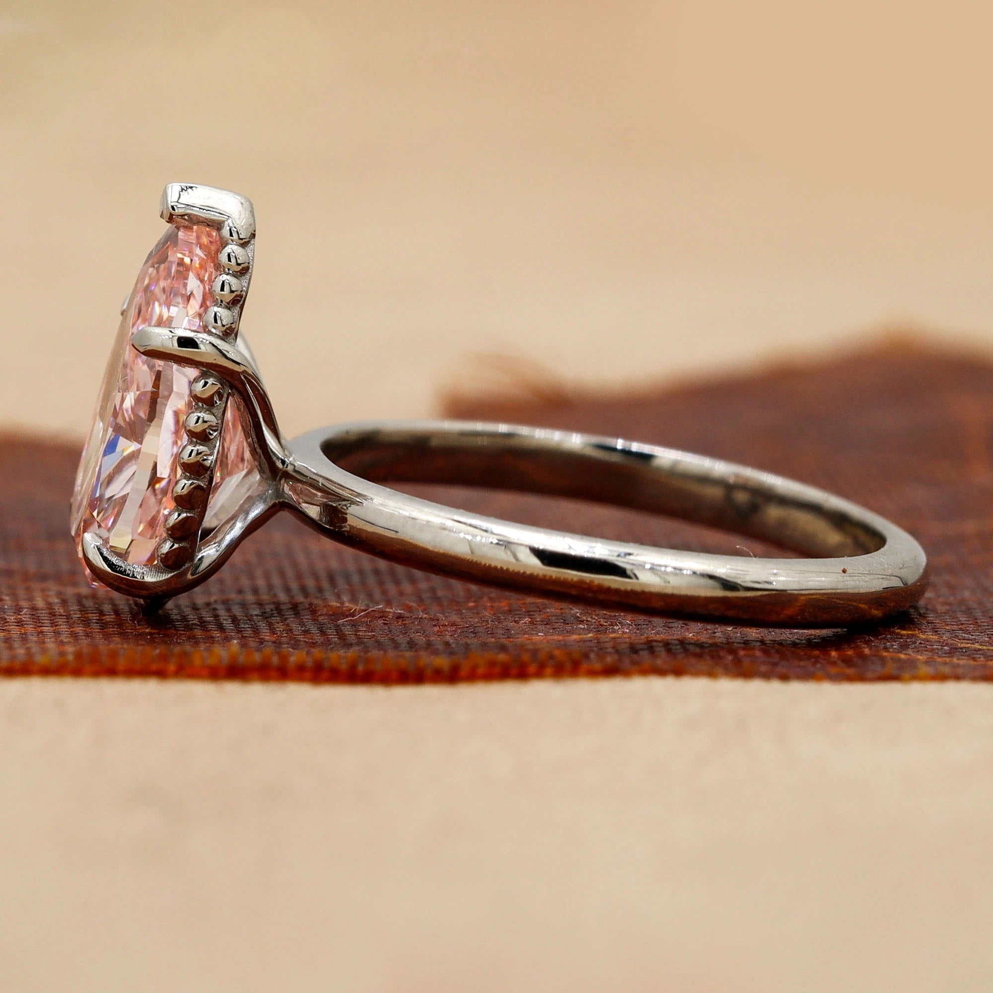 Side view of 3 Carat Pink Pear Cut Diamond Solitaire Ring with Plain Band in Prong Setting